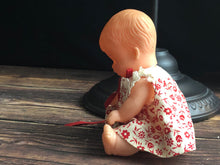 Load image into Gallery viewer, Vintage Drink and Wet 5-1/2" Baby Doll Rubber Head Molded Hair in a White and Red Floral Dress, Buddha Belly Baby Doll