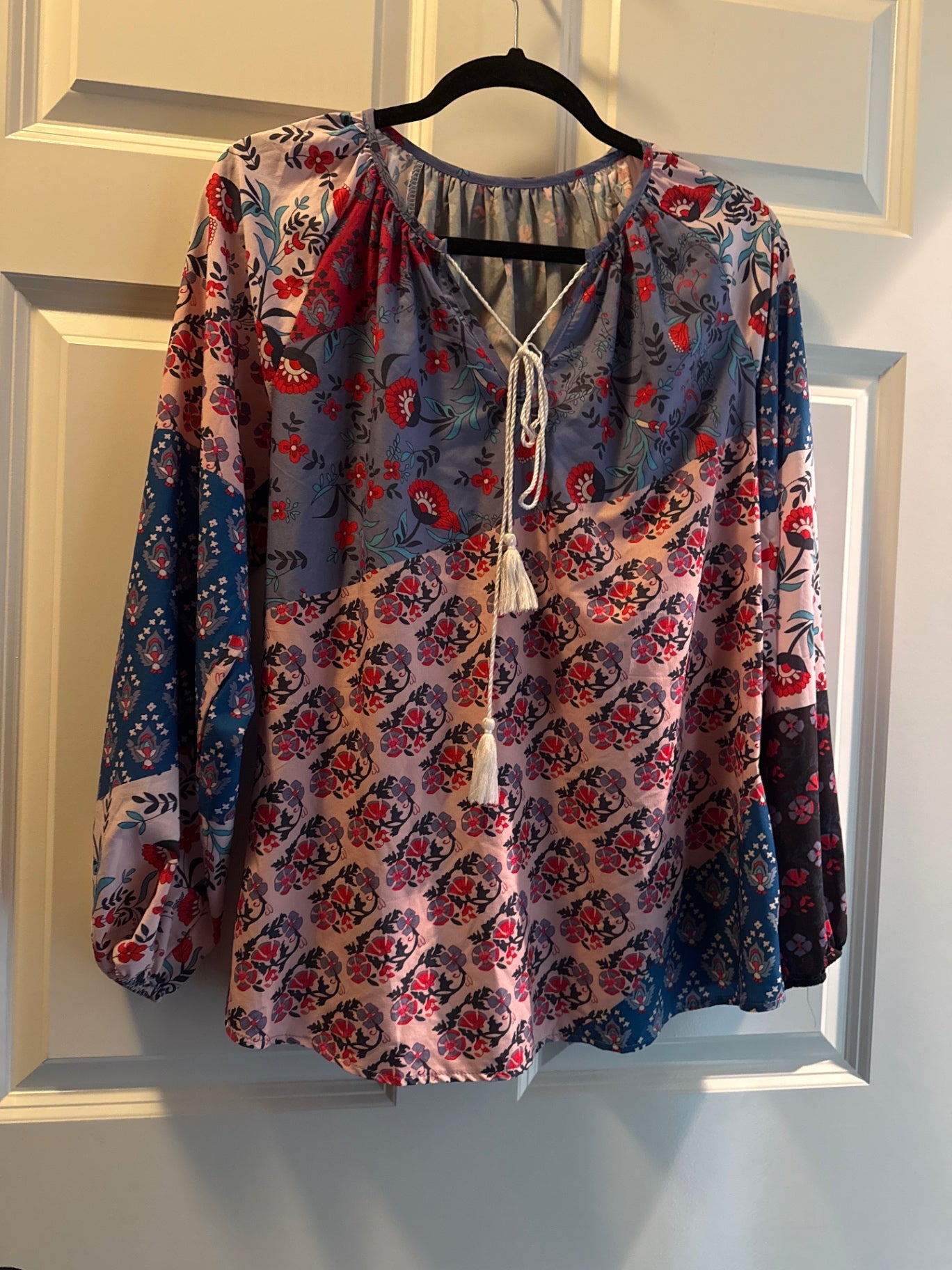 Multicolor (predominantly pink, red, blue, and black) Likely chiffon or a similar lightweight fabric Medium Blouse