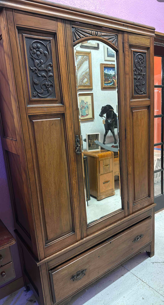 Antique Armoire with Carved Panels and a Mirrored Center