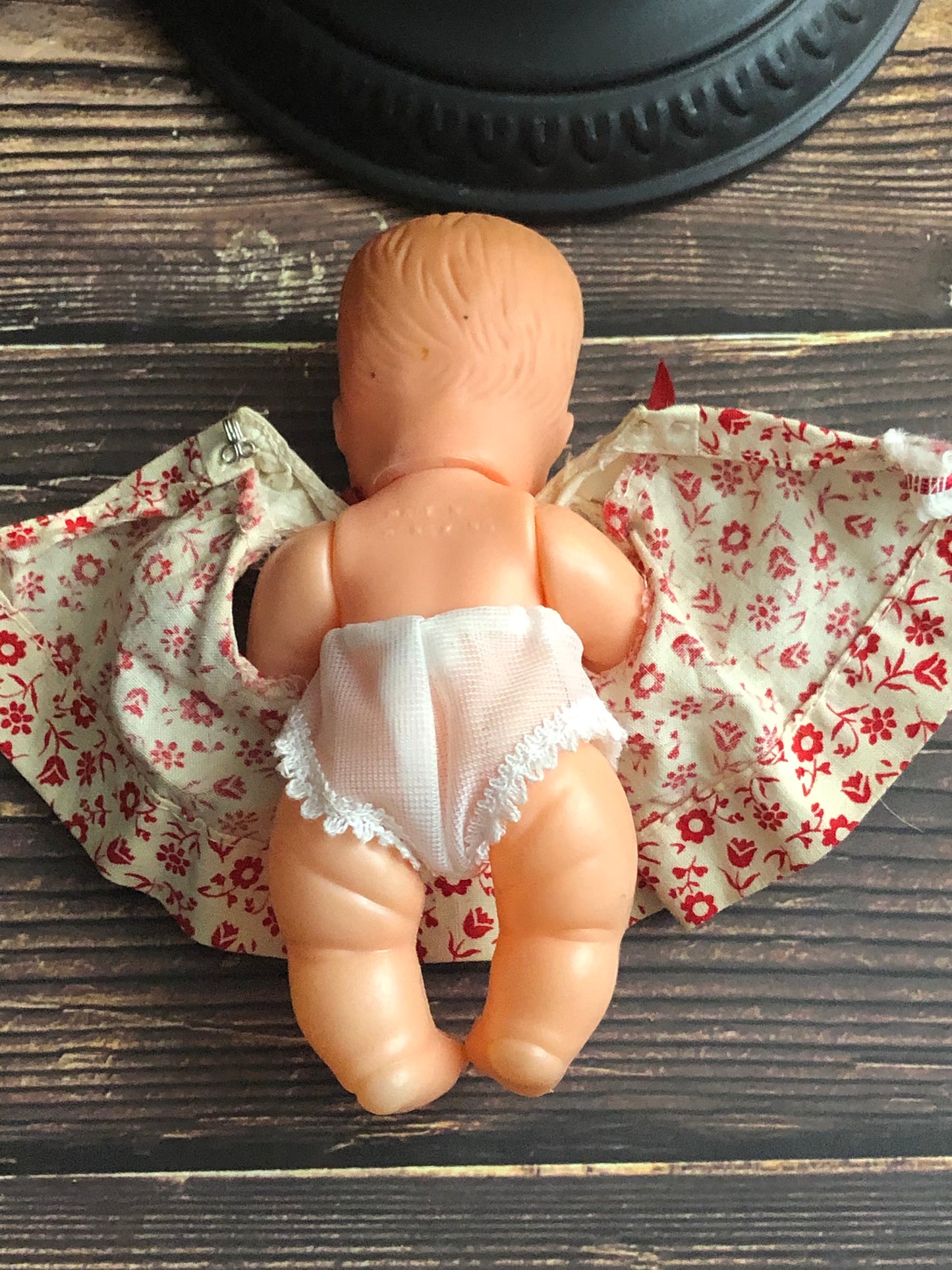 Vintage Drink and Wet 5-1/2" Baby Doll Rubber Head Molded Hair in a White and Red Floral Dress, Buddha Belly Baby Doll