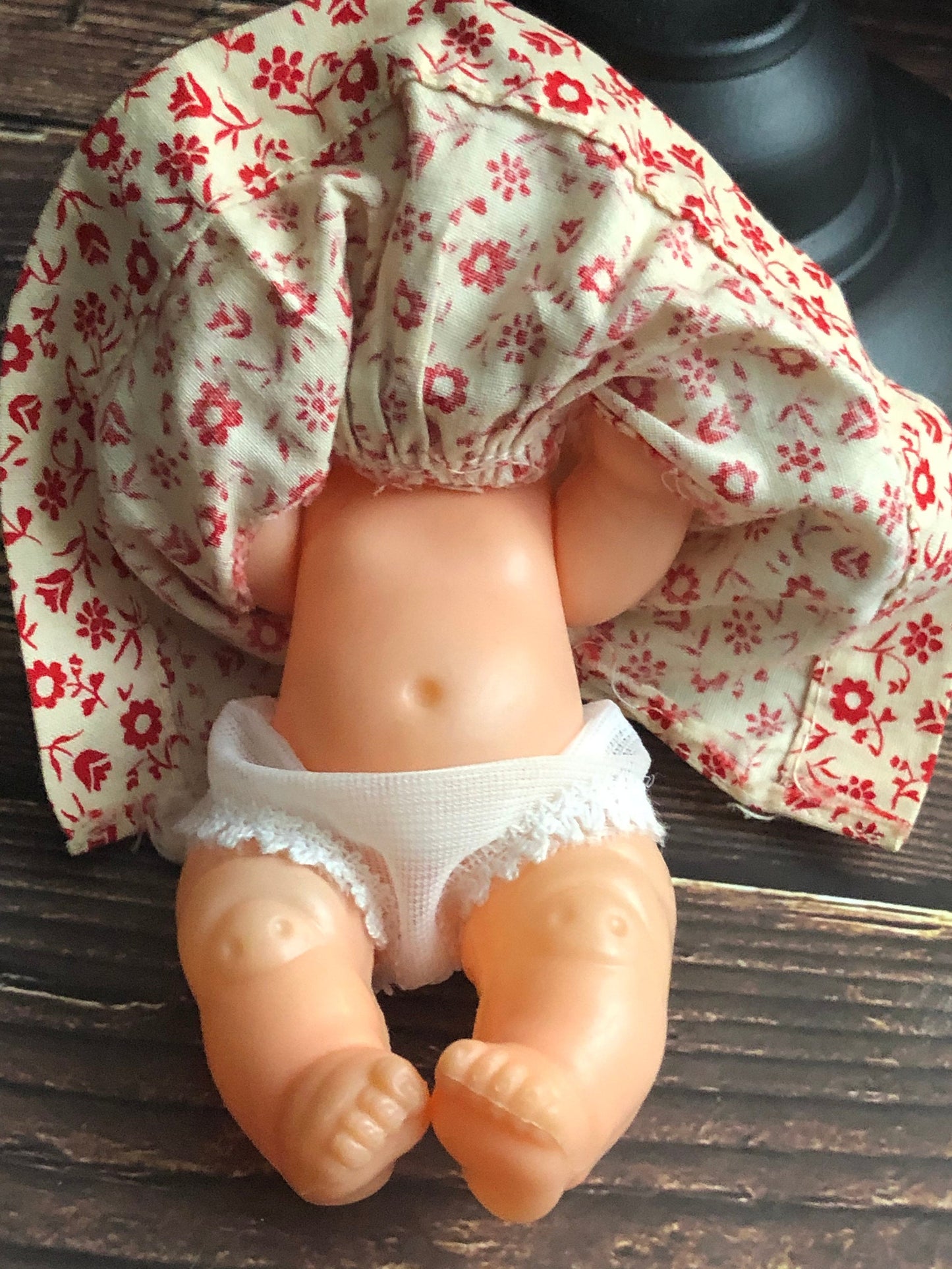 Vintage Drink and Wet 5-1/2" Baby Doll Rubber Head Molded Hair in a White and Red Floral Dress, Buddha Belly Baby Doll