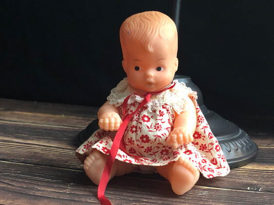 Vintage Drink and Wet 5-1/2" Baby Doll Rubber Head Molded Hair in a White and Red Floral Dress, Buddha Belly Baby Doll